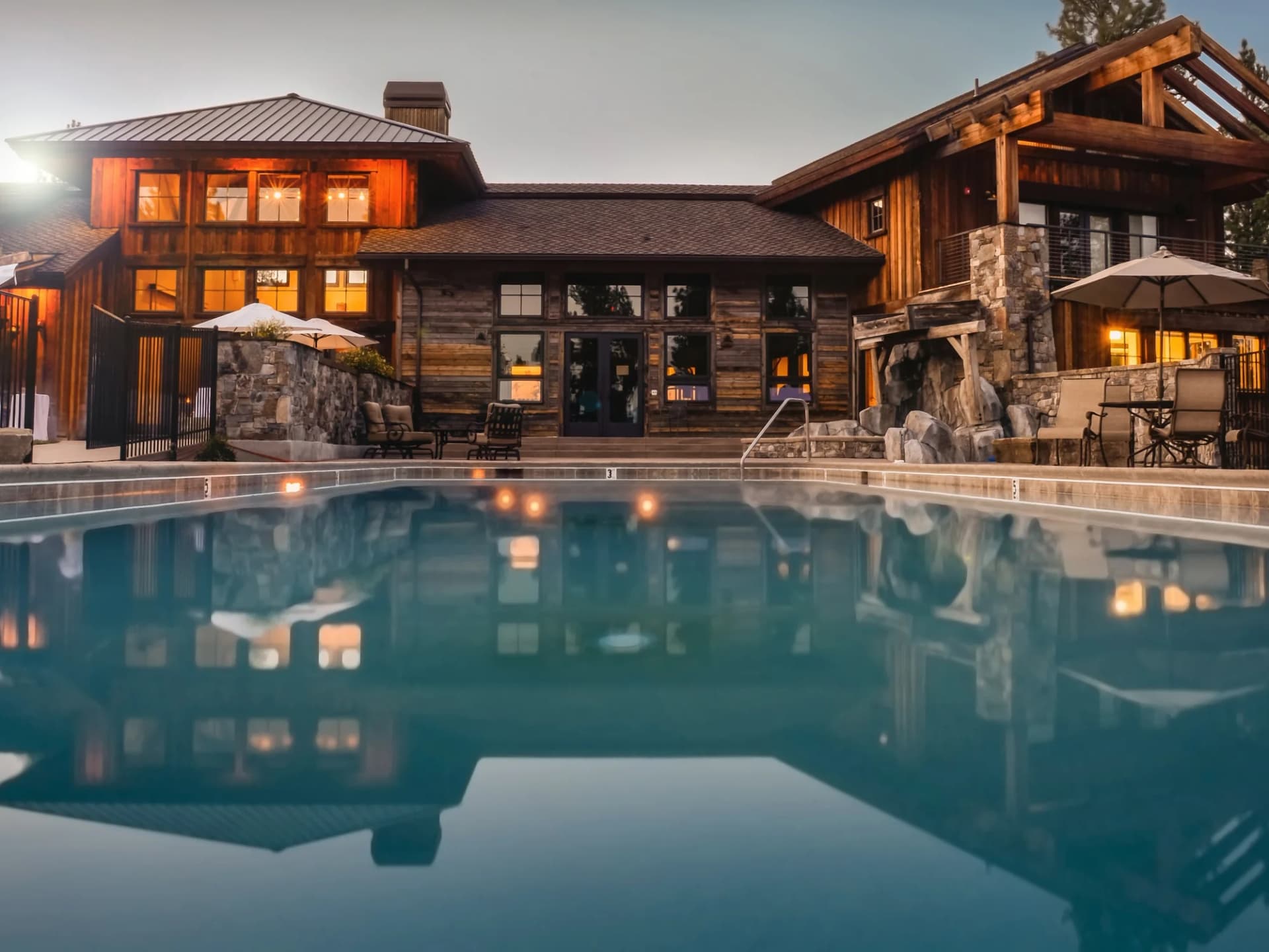 Large private residence with a pool at dusk