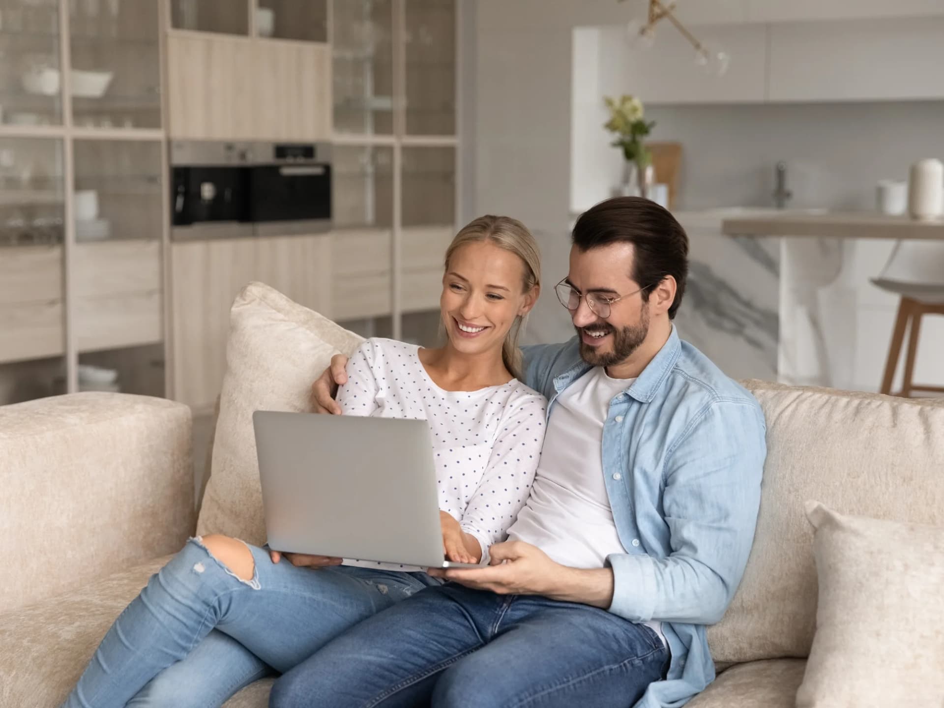Couple at home going through their finances on a laptop
