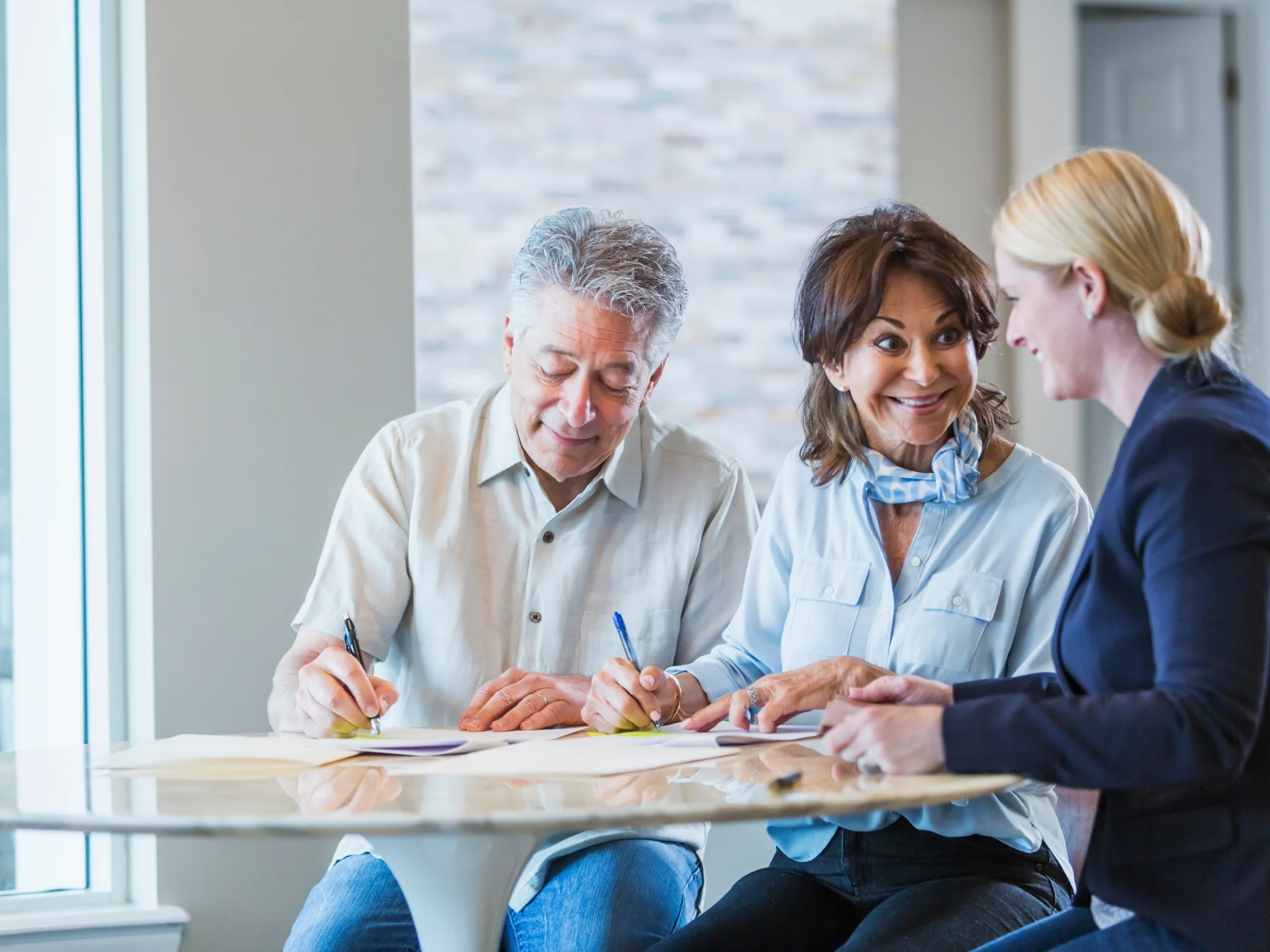 Couple signing estate paperwork with their tax accountant