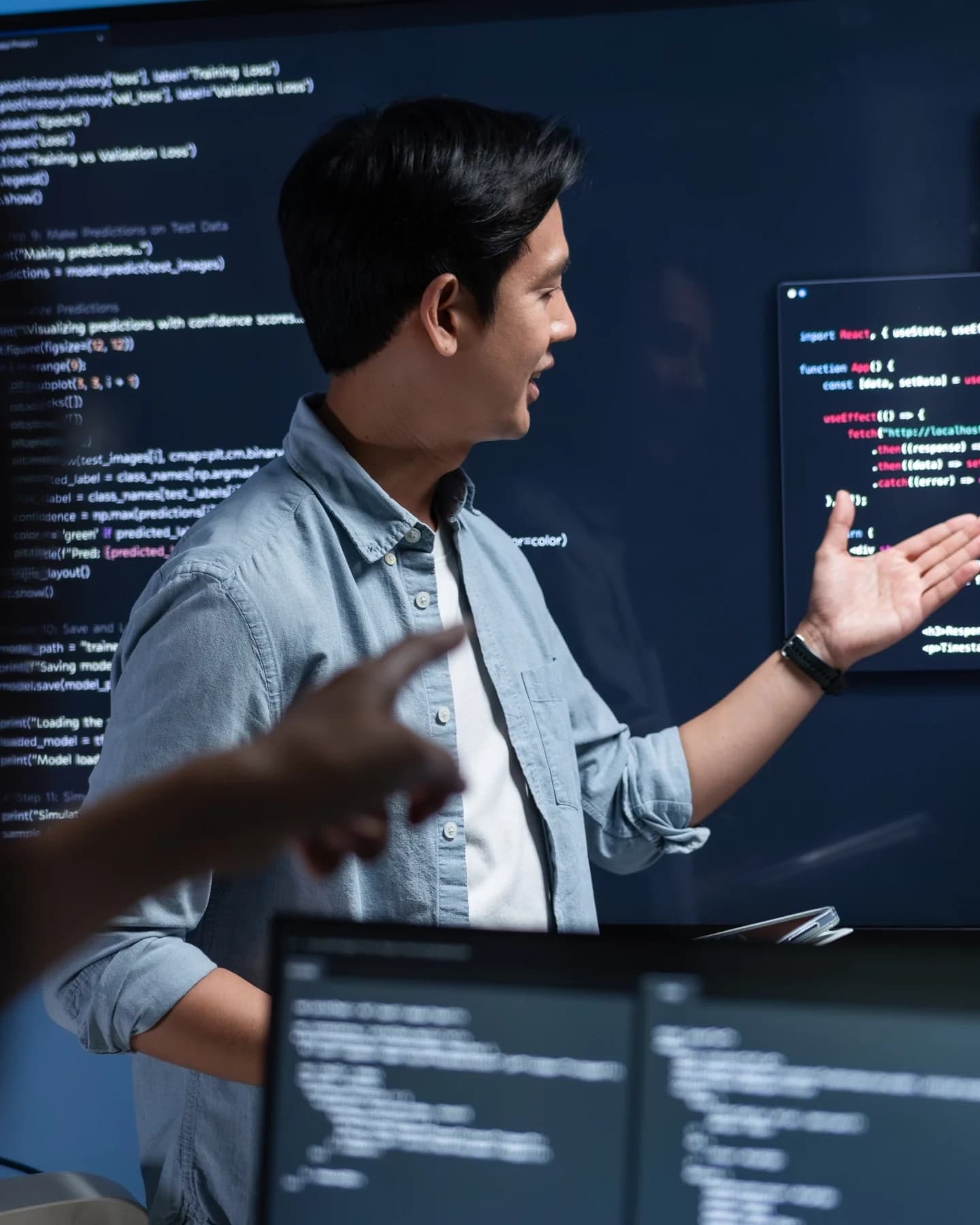 Developer explaining code on a large screen
