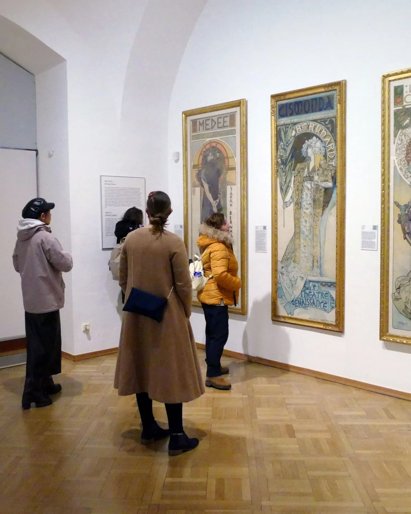 Visitors viewing framed works in a gallery