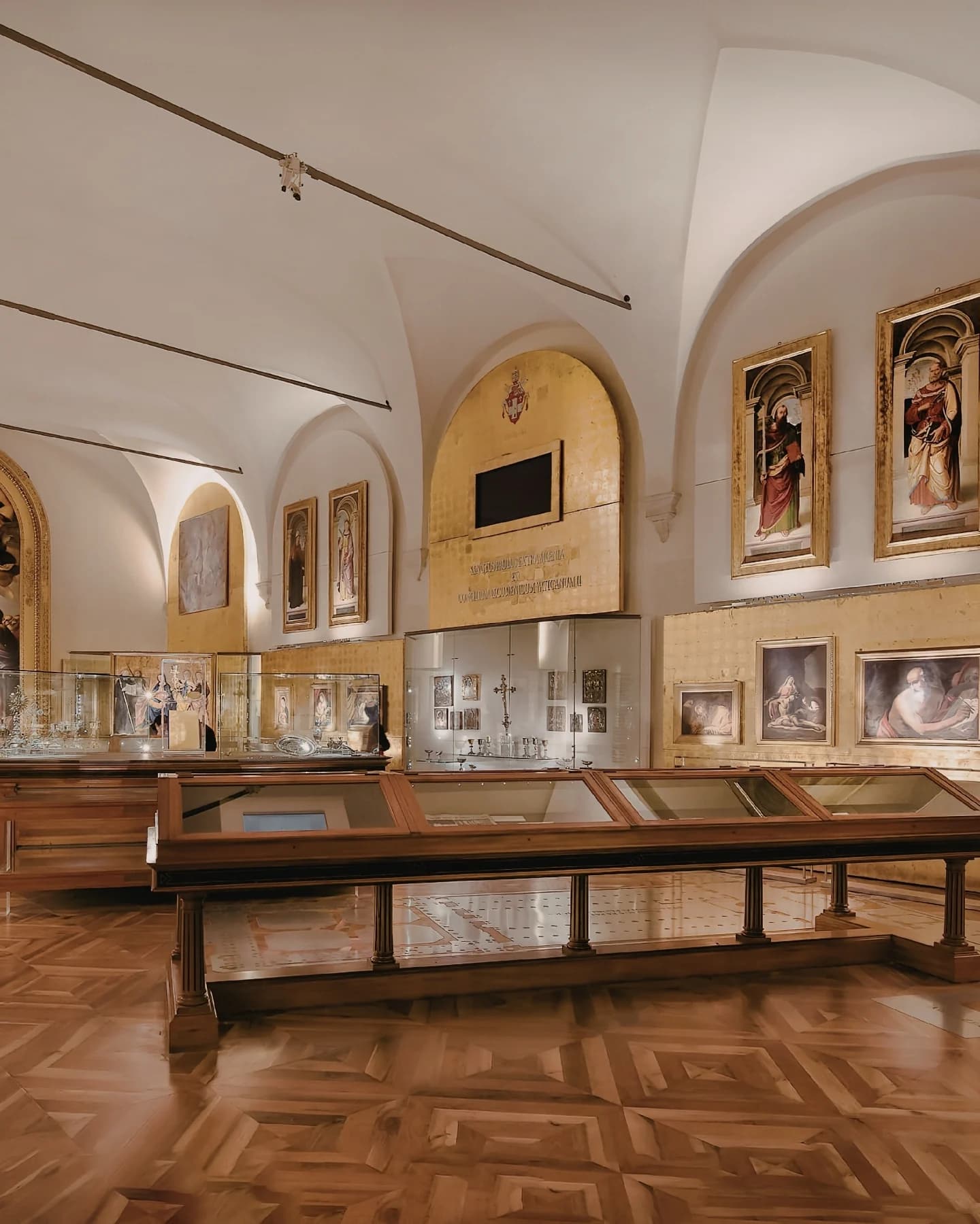 Exhibition hall with paintings and display cases