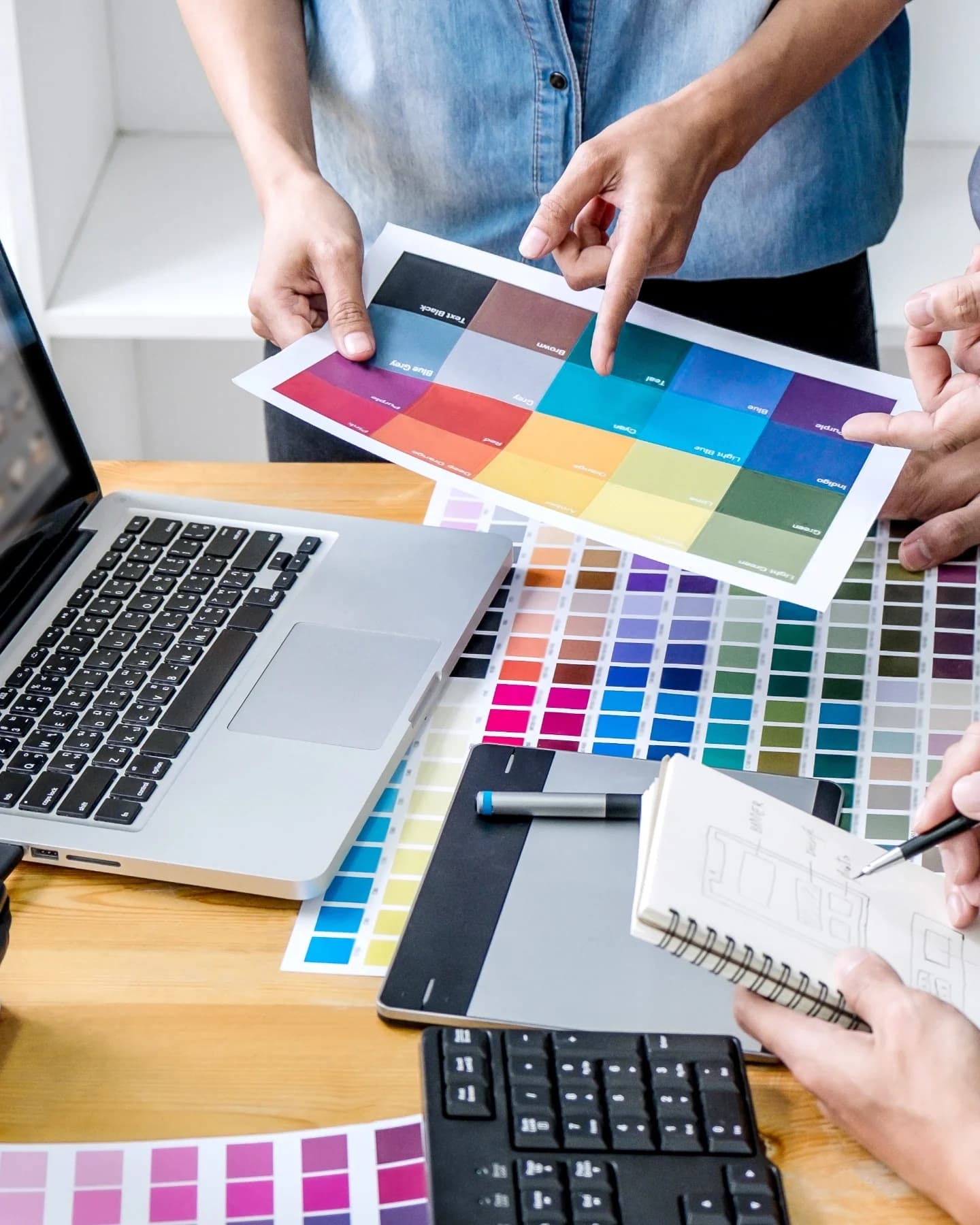 Designers choosing colours from a swatch chart