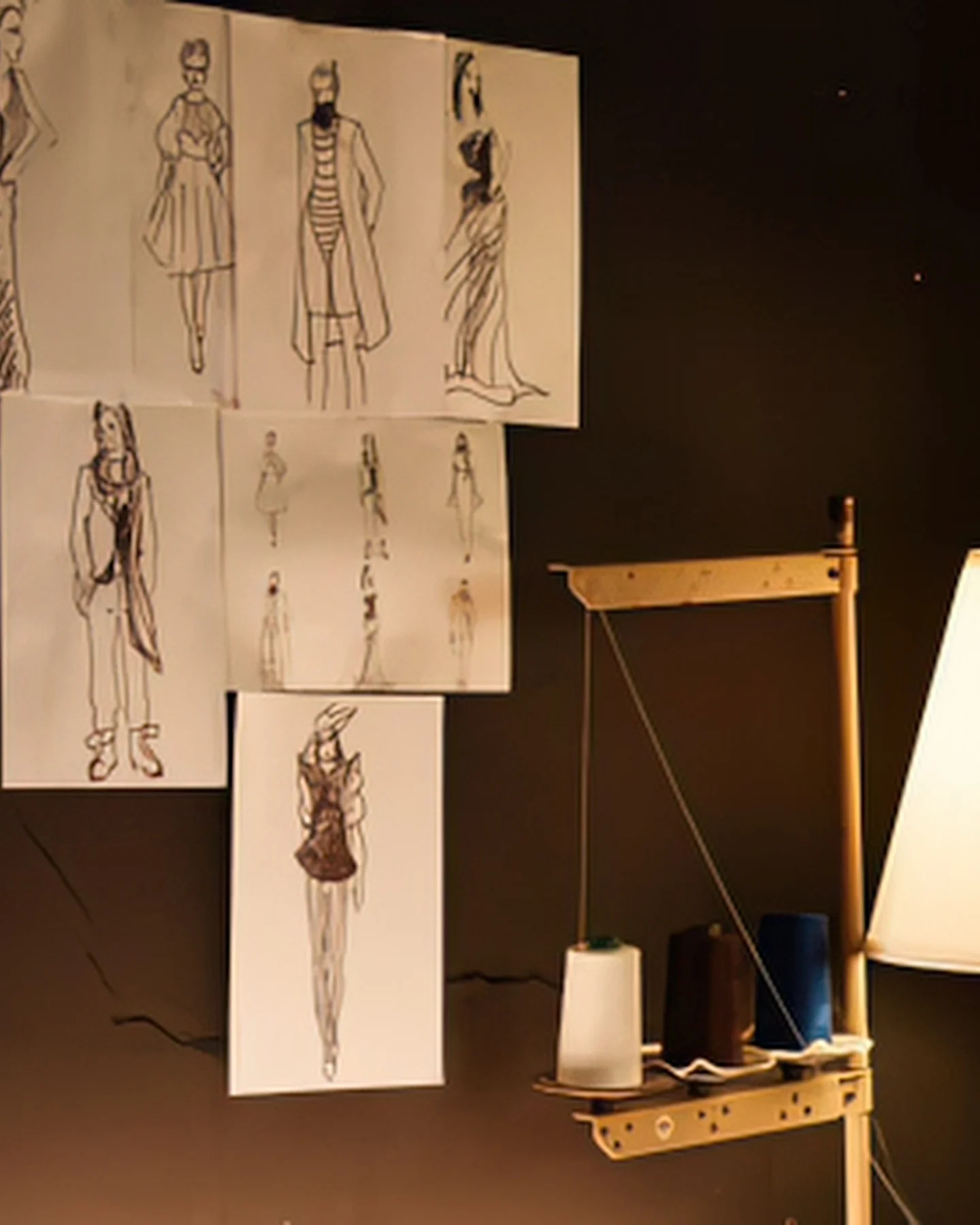 Fashion sketches pinned to an atelier wall