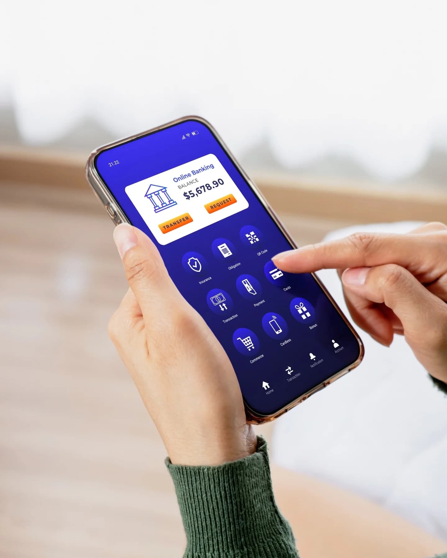 Hands using a banking app on a phone