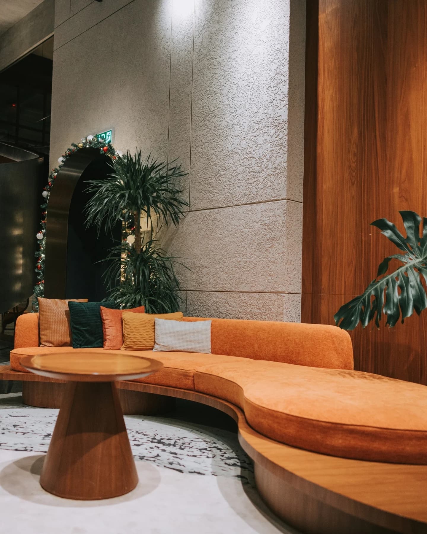 Hotel lounge with a curved sofa and low tables
