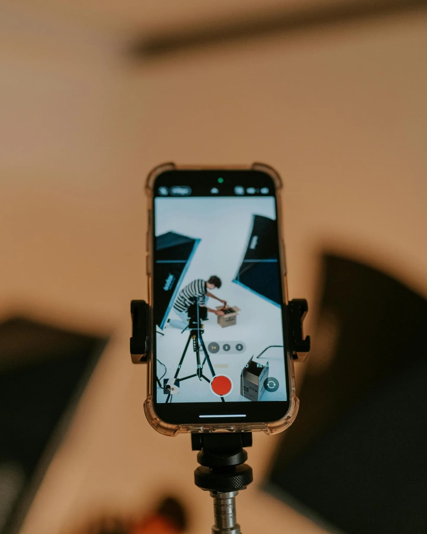 Phone mounted on a tripod filming a set