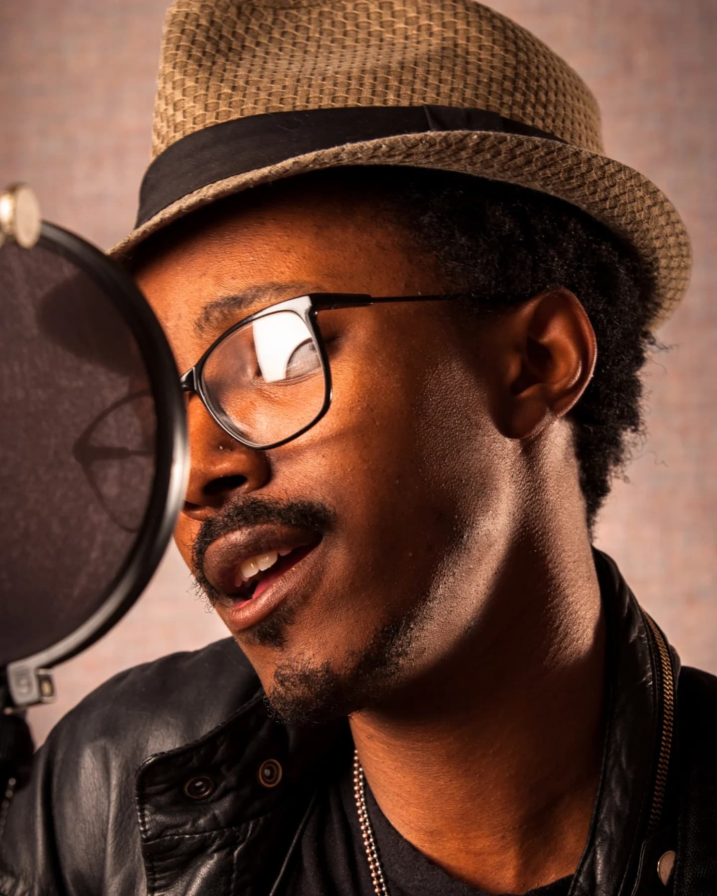 Singer recording at a studio microphone
