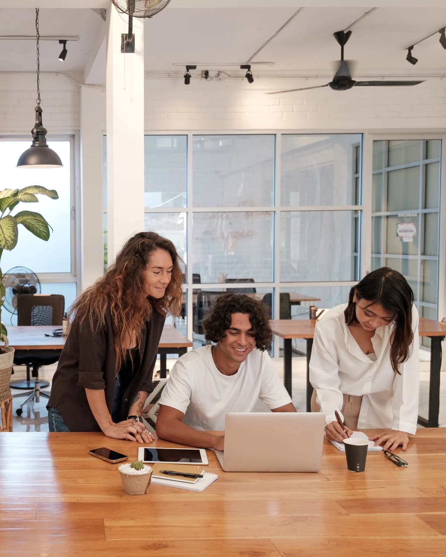Three colleagues working together in an open-plan office
