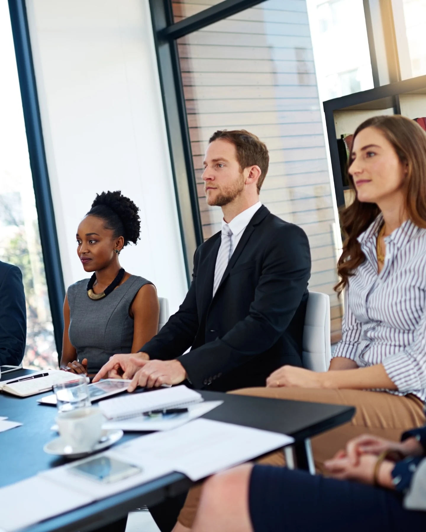 Investors seated along a boardroom table