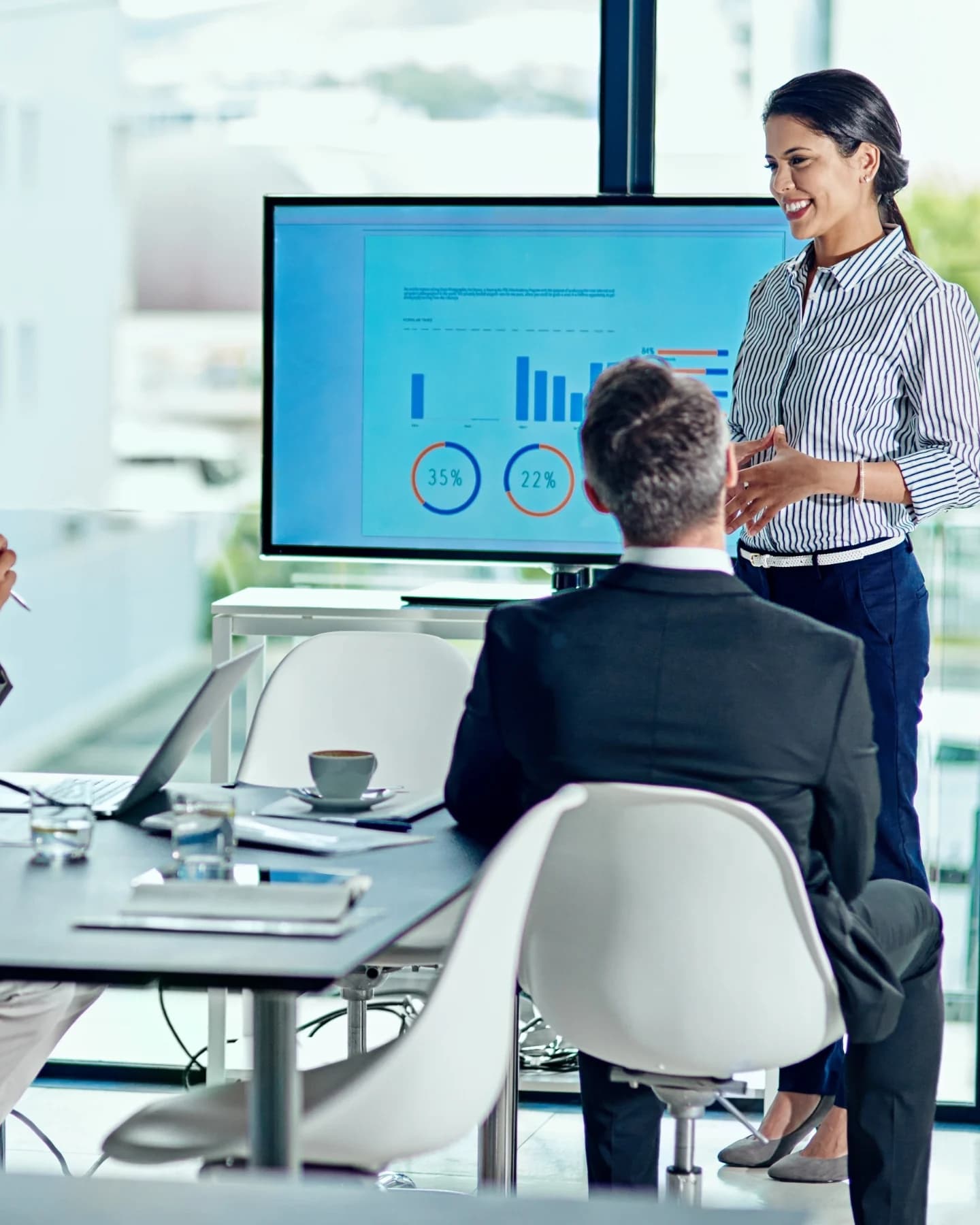 Presentation on a screen in a glass-walled meeting room