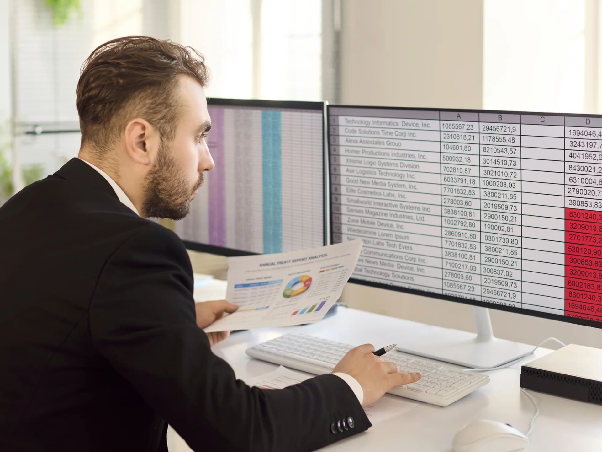 Accountant checking figures against a printed report