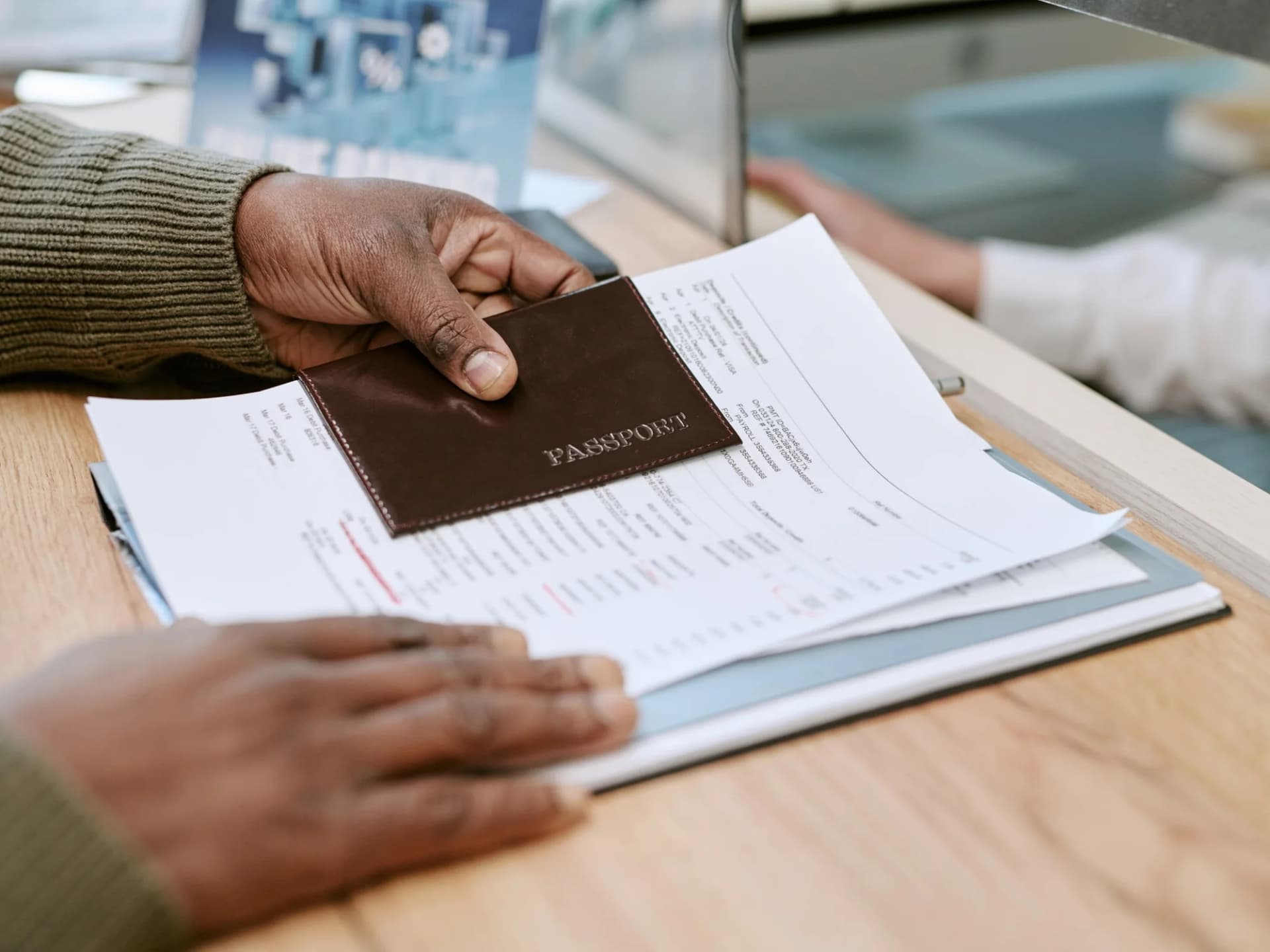 Passport resting on a set of bank statements