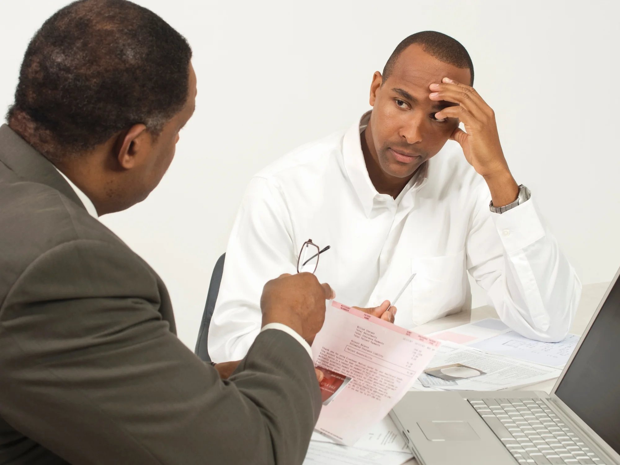 Tax accountant talking a worried client through the paperwork