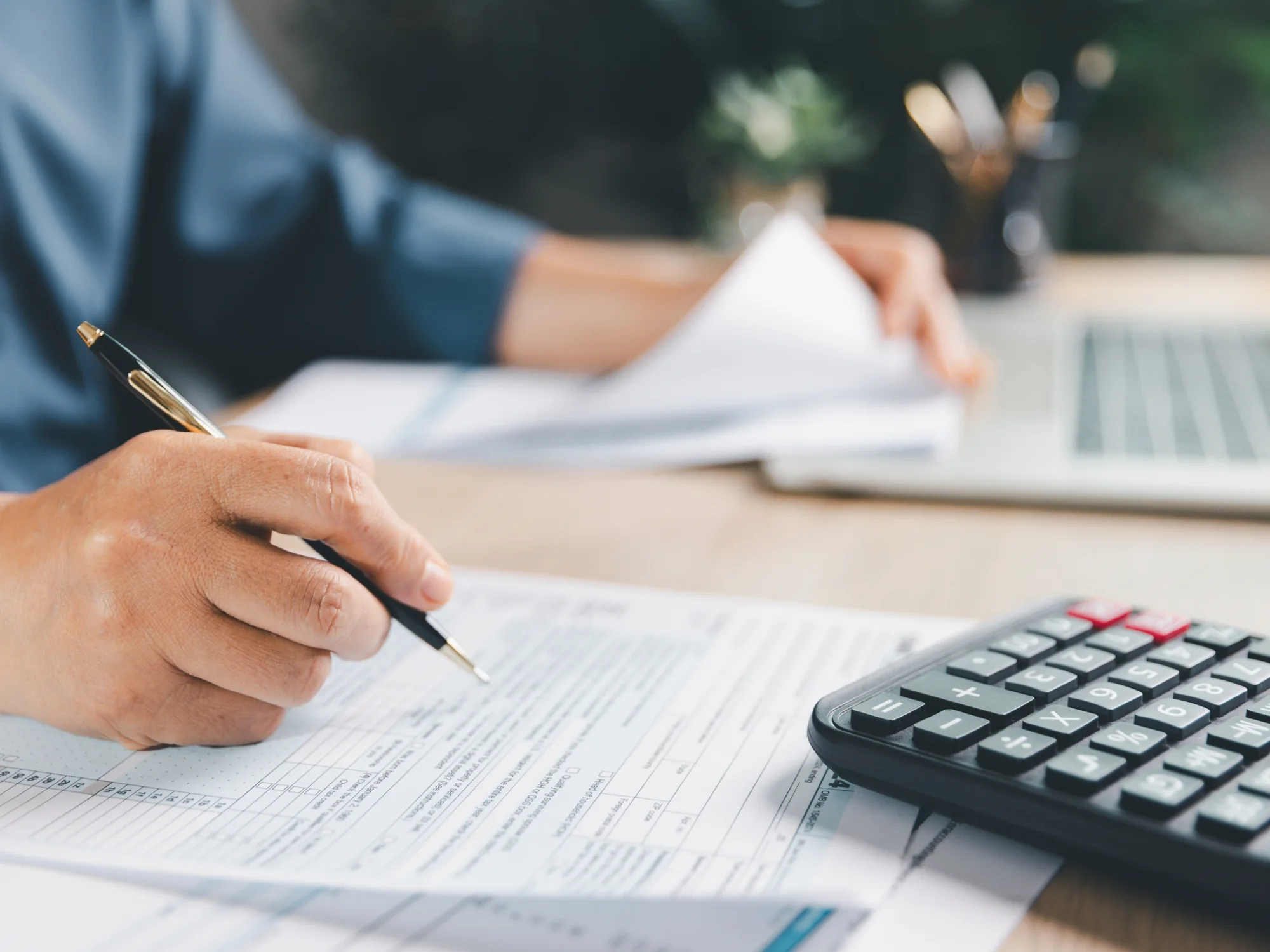 Working through a tax return with a pen and calculator